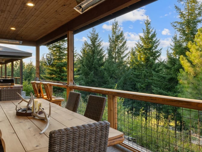Covered deck at Prospector Pines overlooking evergreen forest
